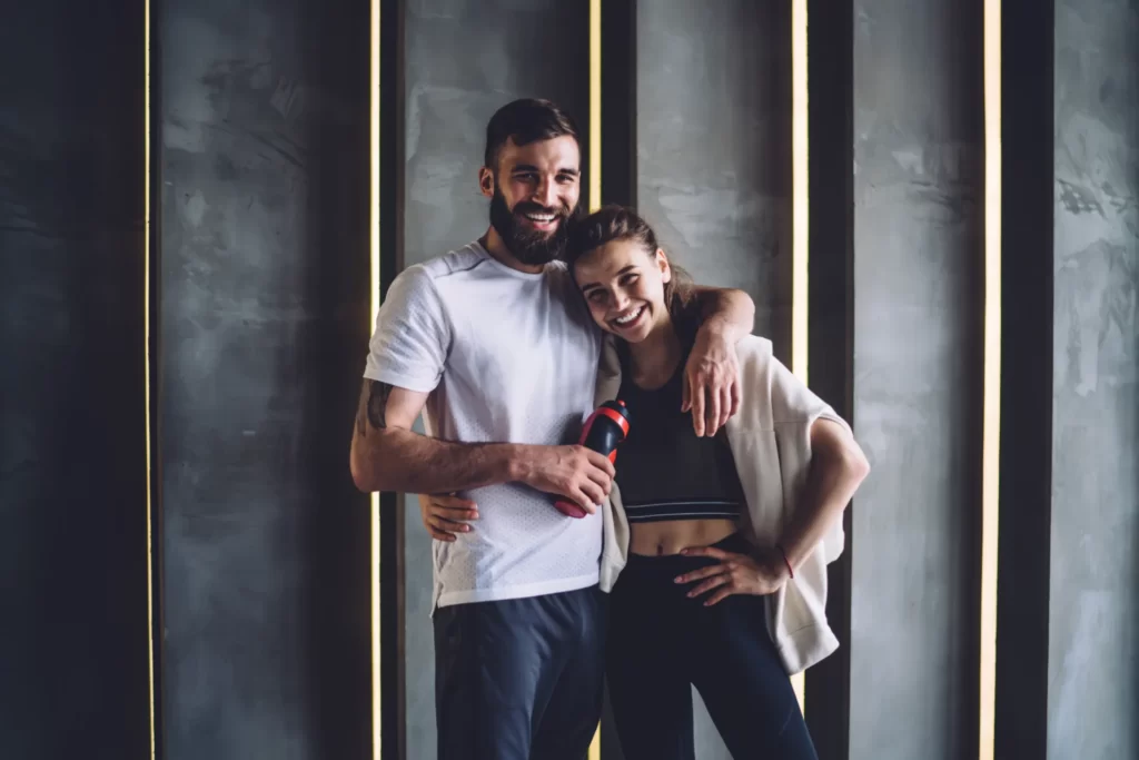 smiling couple embracing after workout utc